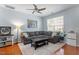 Cozy living room with a large gray sectional, hardwood floors, and a contemporary area rug at 1710 Grace Point Rd, Morrisville, NC 27560