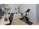 A carpeted office space including a desk, workout bike, and storage shelves at 1710 Grace Point Rd, Morrisville, NC 27560
