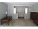 Cozy living room featuring neutral walls, carpet, a brick fireplace, and a view of the home's double doors at 1812 Crepe Myrtle Dr, Sanford, NC 27330