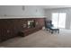 Comfortable living room with a brick fireplace, neutral carpet, and a sliding glass door leading to the outside at 1812 Crepe Myrtle Dr, Sanford, NC 27330
