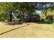 Exterior view of a brick home with a large, mature tree in the front yard at 210 S Hughes St, Apex, NC 27502