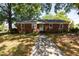 Charming brick home with a well-maintained lawn and a concrete walkway leading to the front door at 210 S Hughes St, Apex, NC 27502