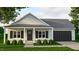 Charming single-story home with covered porch, black shutters, and attached garage at 214 Green Pines Estates Dr, Kenly, NC 27542