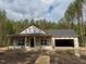 New construction home featuring a covered porch and attached garage under construction at 214 Green Pines Estates Dr, Kenly, NC 27542