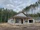 New construction featuring a covered porch, carport, and black framed windows at 214 Green Pines Estates Dr, Kenly, NC 27542