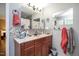 Bathroom showcasing a wood vanity, tiled backsplash, and ample counter space at 220 Cardinal Dr, Youngsville, NC 27596