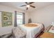 Cozy bedroom with ceiling fan, quilt bedding, natural light from window, and charming decorations at 220 Cardinal Dr, Youngsville, NC 27596