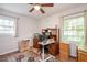 Versatile bedroom space as an office area, with wood floors and a built-in desk by a window at 220 Cardinal Dr, Youngsville, NC 27596