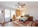 Comfortable bedroom featuring hardwood floors, ceiling fan, and ample natural light at 220 Cardinal Dr, Youngsville, NC 27596