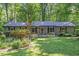 Inviting single-story home with a charming front porch, lush lawn, and a beautifully landscaped front yard at 220 Cardinal Dr, Youngsville, NC 27596