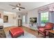 Open-concept living room with hardwood floors, ceiling fan, a television, and a cozy sitting area at 220 Cardinal Dr, Youngsville, NC 27596