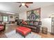 Comfortable living room with hardwood floors, ceiling fan, decorative quilt, and a plush brown sofa at 220 Cardinal Dr, Youngsville, NC 27596