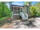 Screened in porch and stairs lead down to a concrete patio nestled in a wooded area at 220 Cardinal Dr, Youngsville, NC 27596