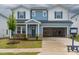 Charming two-story home with an attached two-car garage, landscaped yard, and a partially brick facade at 2226 Cherry Creek Rd, Haw River, NC 27258