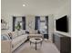 Spacious living room featuring modern furnishings, a large sectional sofa, and contemporary decor at 2226 Cherry Creek Rd, Haw River, NC 27258