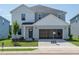 Two-story home with light gray siding, white trim, an attached two-car garage, and a neatly manicured front lawn at 2230 Cherry Creek Rd, Haw River, NC 27258