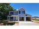 Charming two-story home boasts a covered front porch and an attached two-car garage, perfect for any Gathering at 2554 Whitetail Rd, Nashville, NC 27856