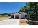 Newly constructed single-story home with an attached two-car garage and a concrete driveway at 2555 Whitetail Rd, Nashville, NC 27856