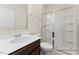 Bathroom showcasing a white sink vanity with dark wood cabinets and a glass-enclosed shower at 260 Curling Creek Dr # 235P, Clayton, NC 27527