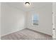 This cozy bedroom features neutral carpet, one window and white walls at 260 Curling Creek Dr # 235P, Clayton, NC 27527