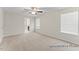 Bright bedroom with neutral walls, plush carpet, ceiling fan, and a glimpse into an ensuite bathroom at 260 Curling Creek Dr # 235P, Clayton, NC 27527
