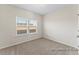 Bright bedroom with plush carpet, natural light, and neutral walls, creating a cozy atmosphere at 260 Curling Creek Dr # 235P, Clayton, NC 27527