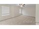 Bright, spacious bedroom featuring plush carpeting, a ceiling fan, and large windows for natural light at 260 Curling Creek Dr # 235P, Clayton, NC 27527