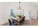 Inviting dining area with a rustic wood table set beneath a modern light fixture creating a warm and stylish atmosphere at 260 Curling Creek Dr # 235P, Clayton, NC 27527
