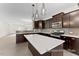 Modern kitchen featuring a large island, stainless steel appliances, dark cabinets, and stylish pendant lighting at 260 Curling Creek Dr # 235P, Clayton, NC 27527