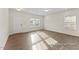 Open living room with wood-look floors, natural light, and direct access to front entrance at 260 Curling Creek Dr # 235P, Clayton, NC 27527