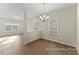 Bright living room with hardwood flooring, modern lighting, and a view into the dining area at 260 Curling Creek Dr # 235P, Clayton, NC 27527