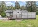 Back deck with weathered gray planks and a partial privacy screen in a spacious, grassy yard at 2746 Saint Lukes Church Rd, Goldston, NC 27252