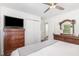 Bedroom boasts dark wood furniture, a ceiling fan, and two windows providing natural light at 2746 Saint Lukes Church Rd, Goldston, NC 27252