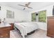 Bright bedroom featuring two windows, neutral walls, ceiling fan, and carpeted flooring at 2746 Saint Lukes Church Rd, Goldston, NC 27252