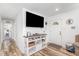 Inviting entryway featuring a console table with TV and decor adjacent to the front door at 2746 Saint Lukes Church Rd, Goldston, NC 27252