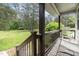 View of the porch with dark wood trim and rocking chairs overlooking the front yard at 2746 Saint Lukes Church Rd, Goldston, NC 27252