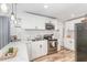 Bright kitchen with stainless steel appliances, subway tile backsplash and white cabinetry at 2746 Saint Lukes Church Rd, Goldston, NC 27252