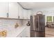 Bright kitchen featuring white cabinets, quartz countertops and a stainless steel refrigerator at 2746 Saint Lukes Church Rd, Goldston, NC 27252