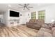 Comfortable living room with a ceiling fan, modern floors and neutral paint at 2746 Saint Lukes Church Rd, Goldston, NC 27252