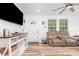 Cozy living room features modern floors, a mounted TV and neutral paint tones at 2746 Saint Lukes Church Rd, Goldston, NC 27252