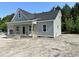 Gray siding and an attached garage accent this single-story home with a welcoming porch and space to be landscaped at 2802 Packing Plant Rd, Smithfield, NC 27577