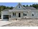 Charming single-story home boasts a welcoming porch, gray siding and an attached garage with natural light and a yard to be landscaped at 2802 Packing Plant Rd, Smithfield, NC 27577