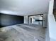 Spacious living room with a dark accent wall leads into a bright, unfinished kitchen, awaiting personalization and finishing touches at 2802 Packing Plant Rd, Smithfield, NC 27577
