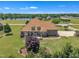 Beautiful brick home with mature landscaping, a manicured lawn, and serene lakeside views from the backyard at 296 Shoreline Dr, Princeton, NC 27569