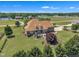 Stately brick home on a large lot features an outdoor fireplace, lush lawn, and lake views at 296 Shoreline Dr, Princeton, NC 27569