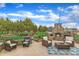 Backyard patio with fireplace, stone grill, chairs, and manicured lawn at 296 Shoreline Dr, Princeton, NC 27569