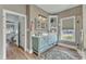 Bright bathroom with double vanity, decorative mirror, and tub with shower at 296 Shoreline Dr, Princeton, NC 27569