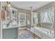 Inviting bathroom with soaking tub, separate shower, and decorative shelving at 296 Shoreline Dr, Princeton, NC 27569