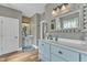 Stylish bathroom with dual sink vanity, decorative mirrors, and tile flooring at 296 Shoreline Dr, Princeton, NC 27569