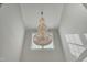 Close-up of a stunning, multi-tiered chandelier hanging in the foyer at 296 Shoreline Dr, Princeton, NC 27569